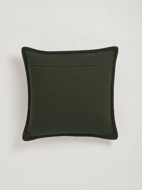 A square olive green throw pillow with dark green stitching around the edges, shown against a light gray background.