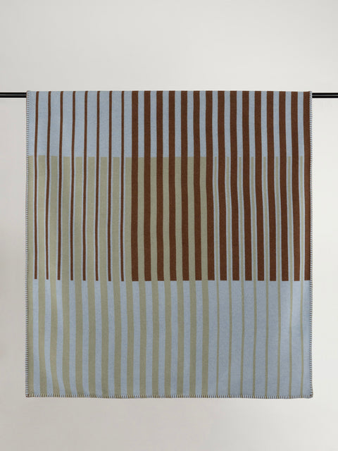 Wool blanket with light blue, brown and tan stripes.
