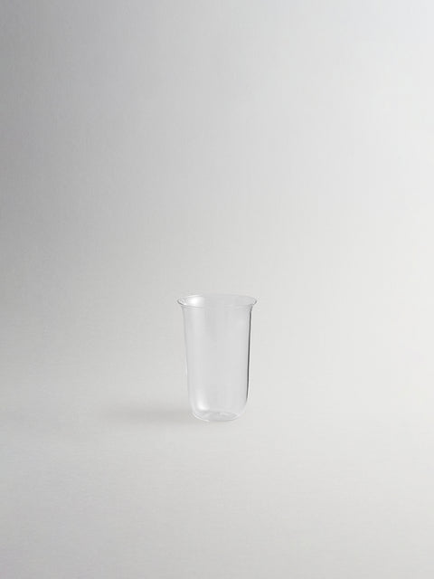 Small clear glass sidecar shown on grey background. 